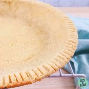 Almond flour pie crust sitting on a wire cooling rack