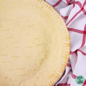 Close up of the coconut flour pie crust with fork marks all over