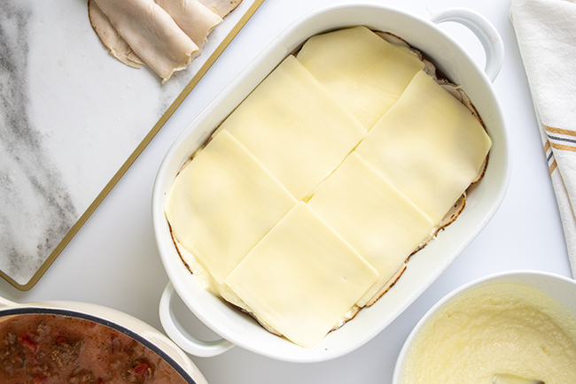 Adding sliced cheese to the low-carb lasagna