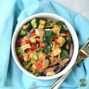 Big bowl of pork stir fry with a silver fork