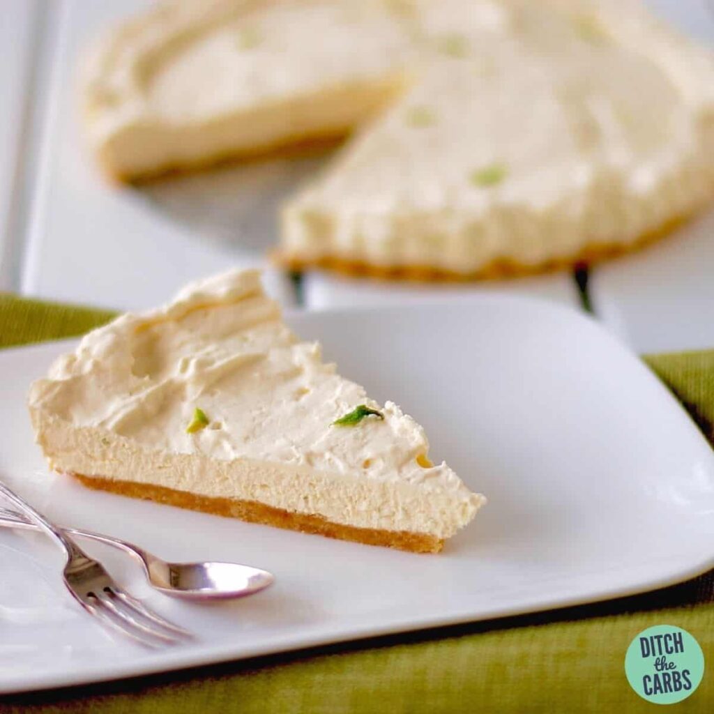 No-Bake Sugar-Free Ginger and Lime Cheesecake sliced and served with silver knife and fork