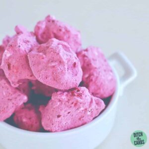 Sugar-free frozen blueberry fat bombs piled into a white bowl
