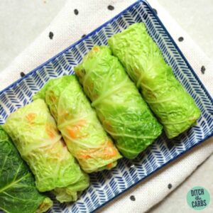 Cabbage leaf spring Rolls served on a blue and white plate