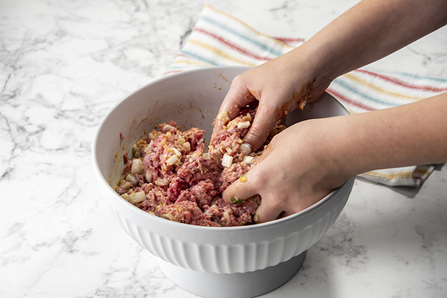 Mixing ingredients together in a bowl for meatloaf