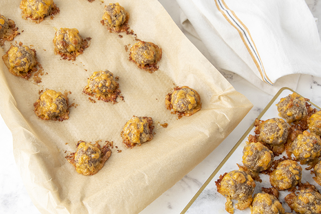 Baked low carb sausage balls on a baking tray