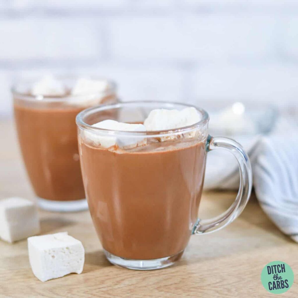 keto hot chocolate in clear glass mugs topped with homemade sugar-free marshmallows