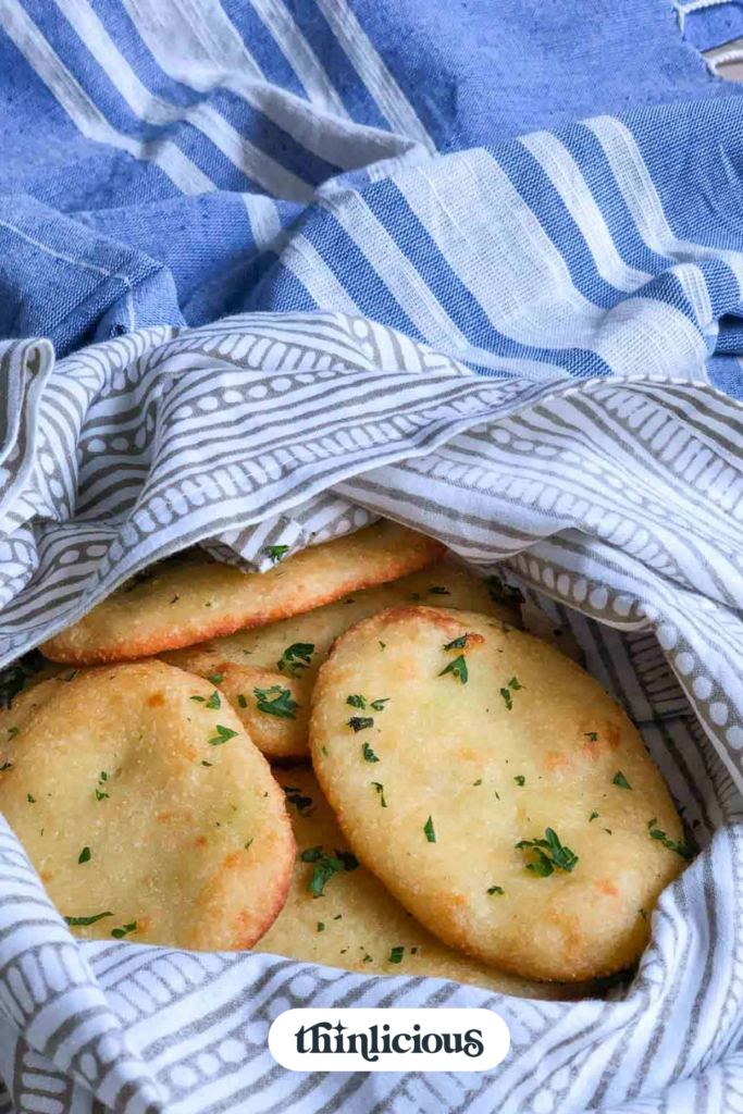 Basket filled with golden brown baked naan